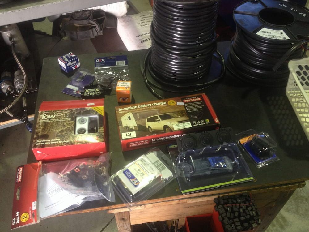 A Table With a Bunch of Items on It Including a Remote Control — Auto Electrical Solutions In Pialba, QLD