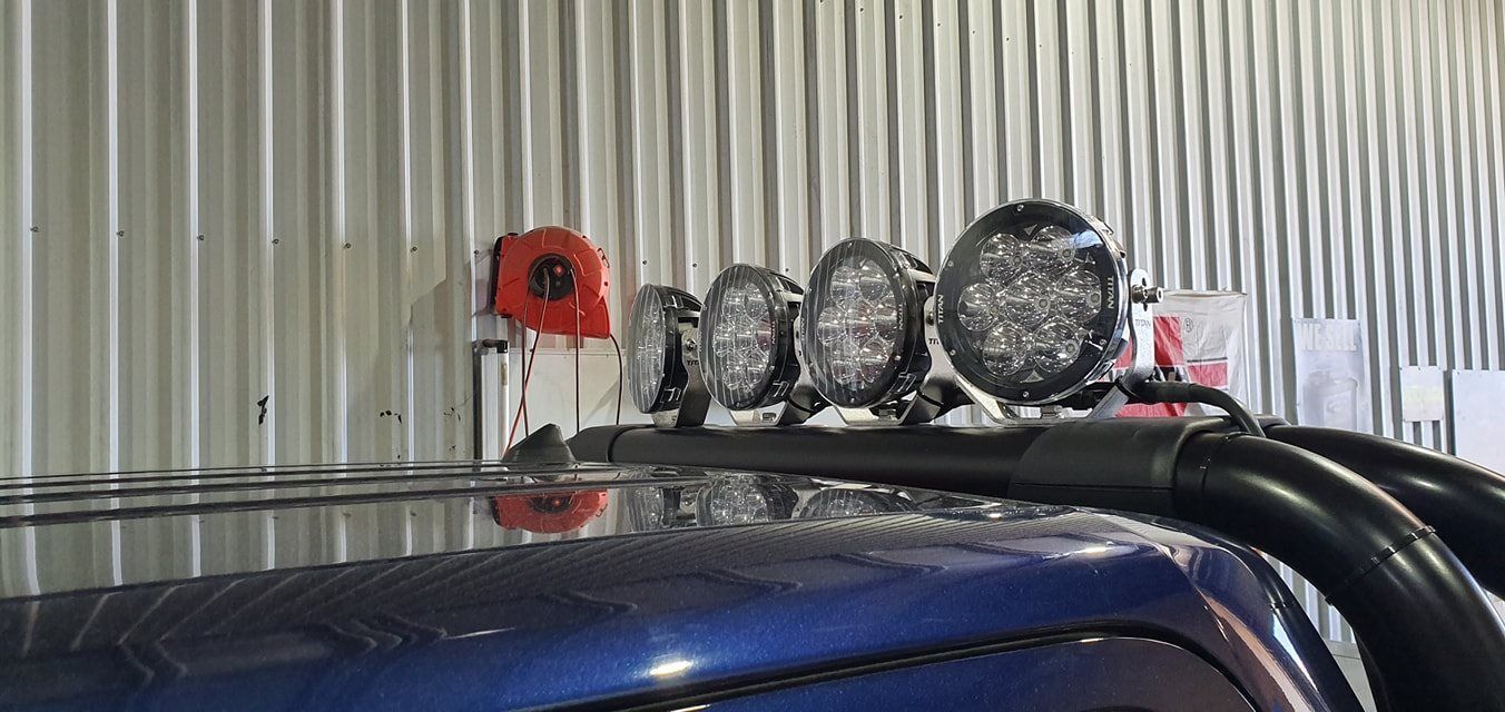 A Blue Truck With Lights on the Roof is Parked in a Garage — Auto Electrical Solutions In Pialba, QLD