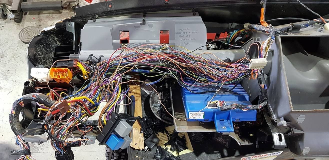 A Bunch Of Wires Are Sitting On Top Of A Car — Auto Electrical Solutions In Pialba, QLD