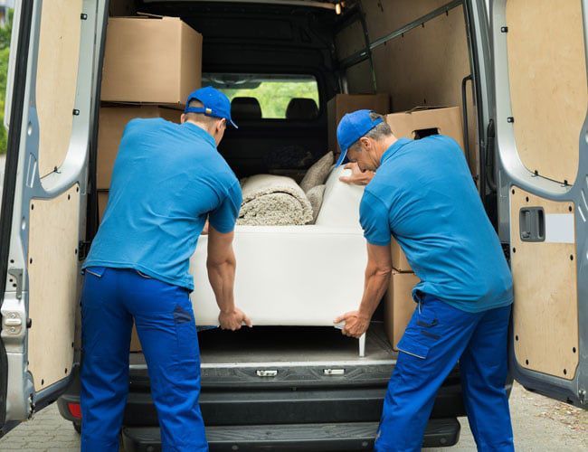 moving team loading furniture into a van moving team loading furniture into a van