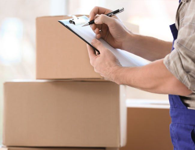 moving team member with a checklist moving team member with a checklist