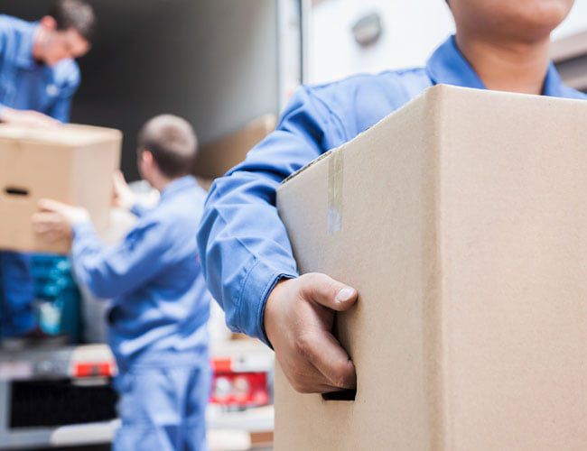moving team unloading a moving truck moving team unloading a moving truck