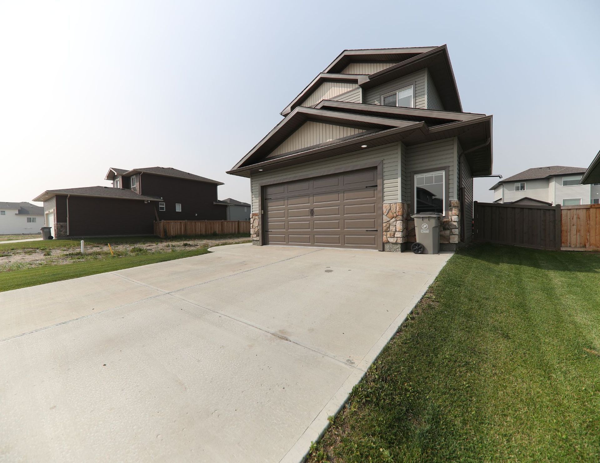 concrete driveway with garage door open