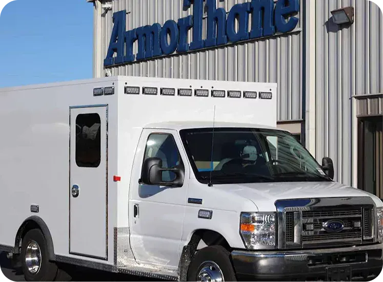 White service truck parked outside a building with an 