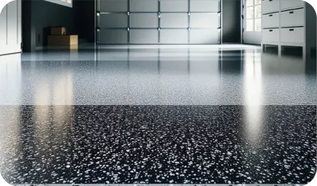 Glossy black speckled epoxy floor in a modern garage with cabinets and soft reflections