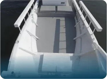 Empty white boat deck with benches and a gray floor, viewed from above