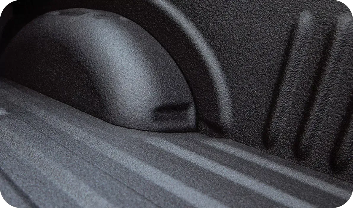 Close-up of a gray car seat with seatbelt strap and headrest