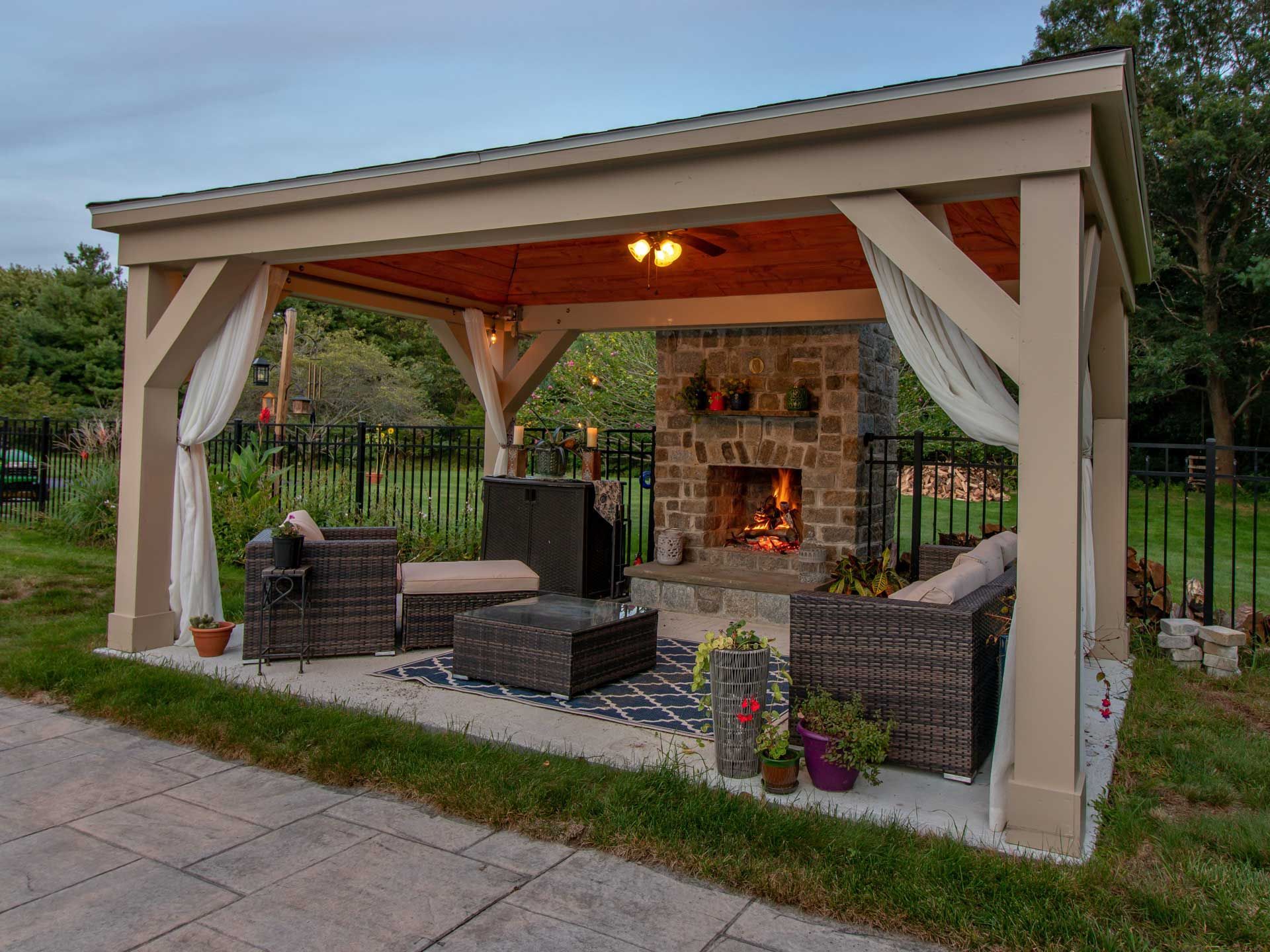 Covered patio with stone outdoor fireplace. Covered patio with stone outdoor fireplace.