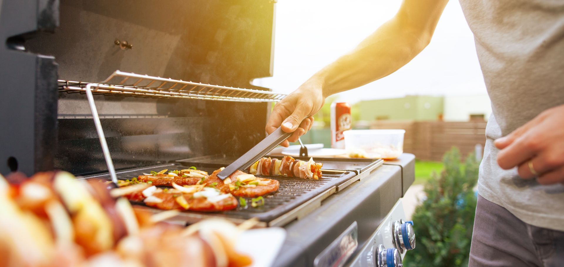 Young man grilling some kind of meats.