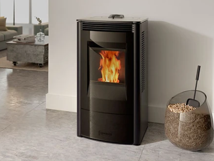 Harman Allure50 Black pellet stove with visible flame in a modern living room beside a woven basket of pellets and a fire poker