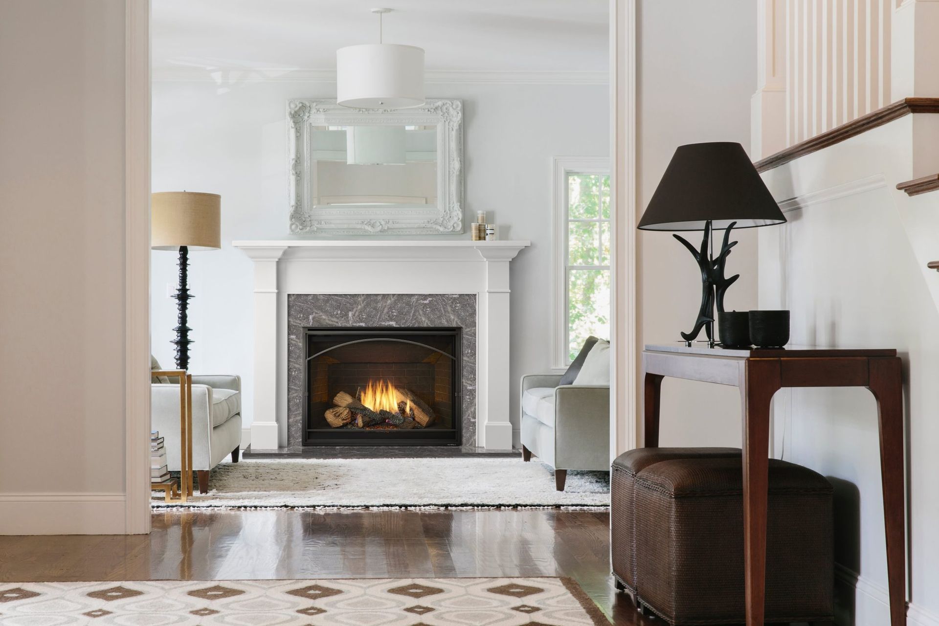 Cozy living room with fireplace, white walls, wood floors, and warm lighting. Cozy living room with fireplace, white walls, wood floors, and warm lighting.