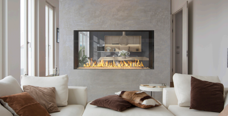 Heat & Glo True Series Modern living room with a wall-mounted fireplace, beige sofas, and large windows letting in soft light