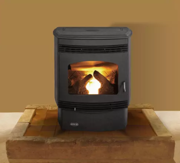 Quadra-Fire Santa-Fe Black stove with glowing fire on a tan hearth against a beige wall