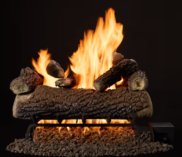 Gas fireplace log set with bright orange flames glowing in a dark hearth