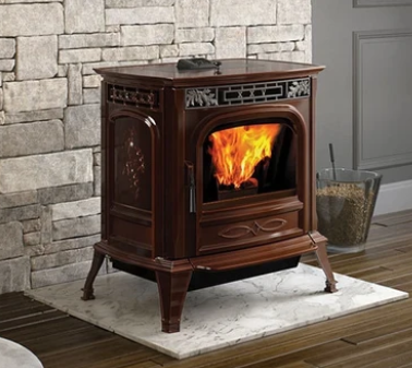Harman XXV-TC Dark wooden fireplace stove with a fire burning, set on a white hearth against a stone wall.