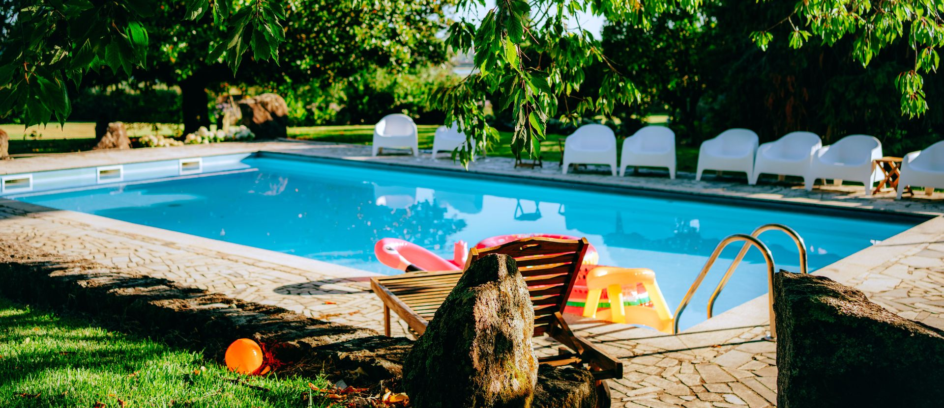 Backyard swimming pool with lounge chairs