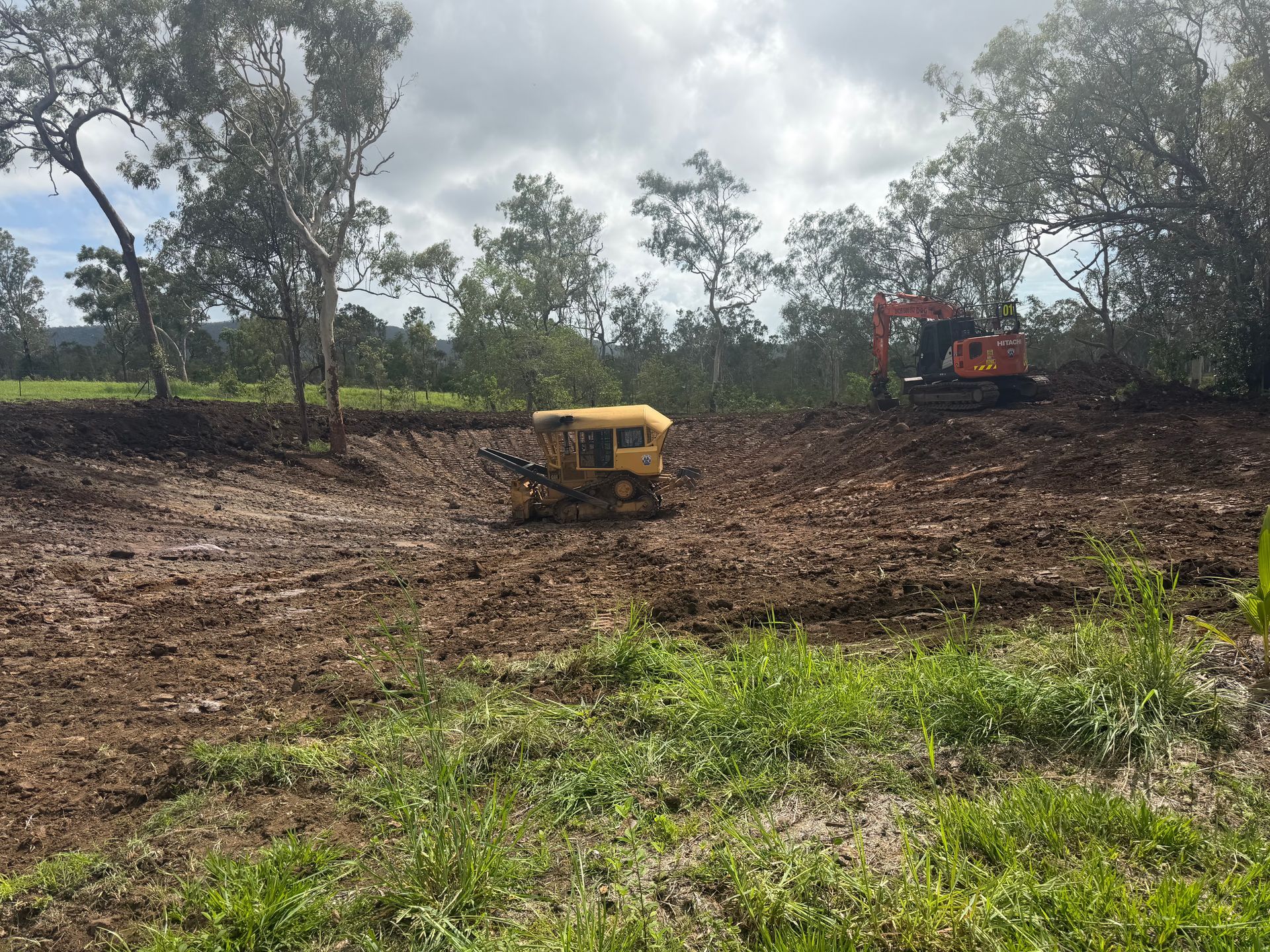 Cleared Field With Yellow Machine In Center — Blue Dog Hire Qld In Midge Point, QLD