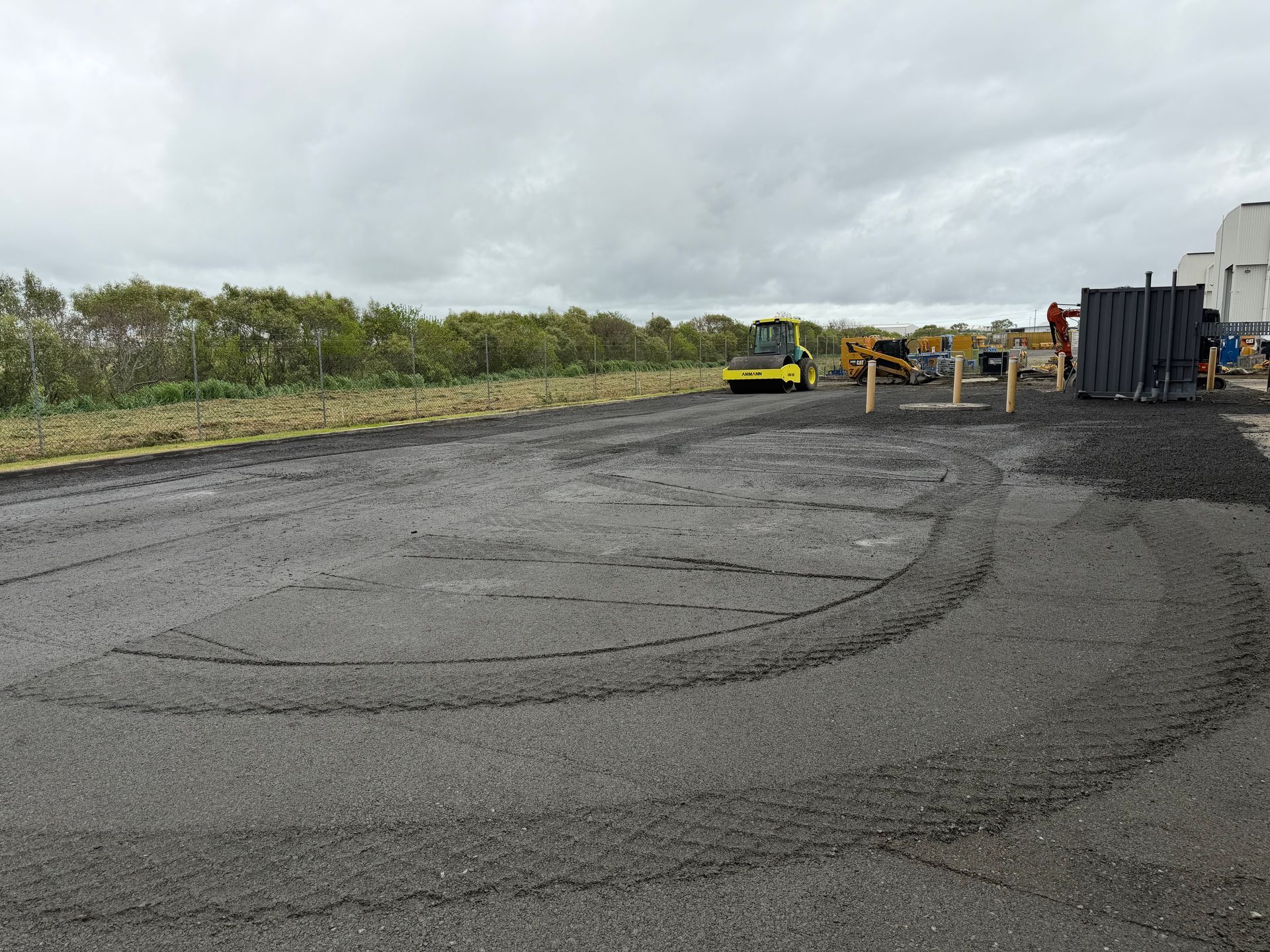 Gravel Lot With Heavy Equipment And Tire Tracks Under Cloudy Skies — Blue Dog Hire Qld In Proserpine, QLD