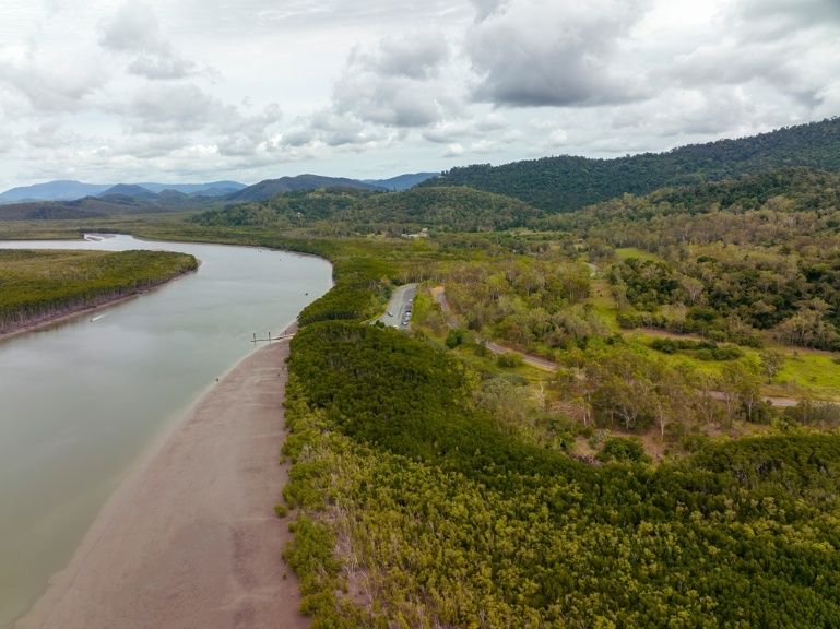 An Aerial View Of A River Surrounded By Trees And Mountains — Blue Dog Hire Qld In Proserpine, QLD