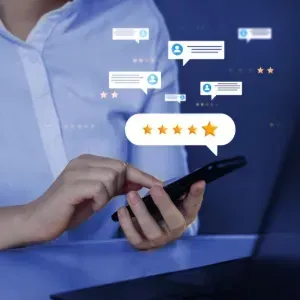 Person using a smartphone with glowing review ratings and chat icons on a blue background