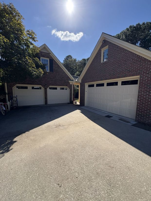 Open garage with bike, tools, and storage.