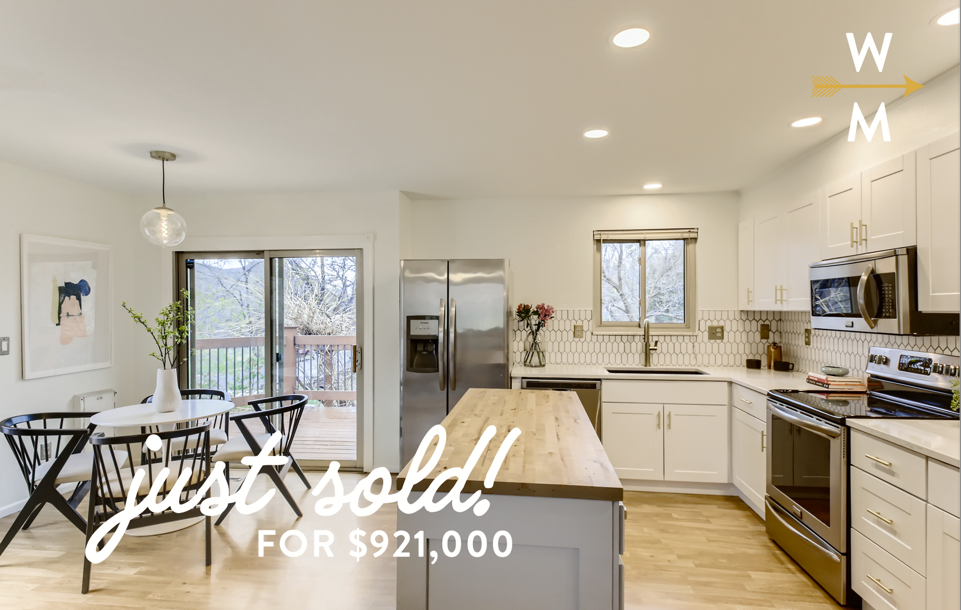 Kitchen and dining area. White cabinets, wood island, stainless steel appliances, sold for $921,000.