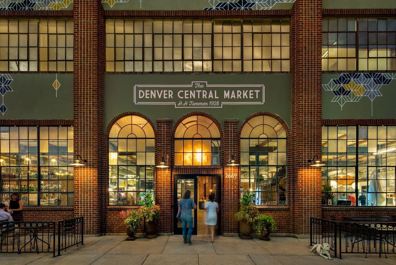 Denver Central Market entrance with people, brick, and large windows.