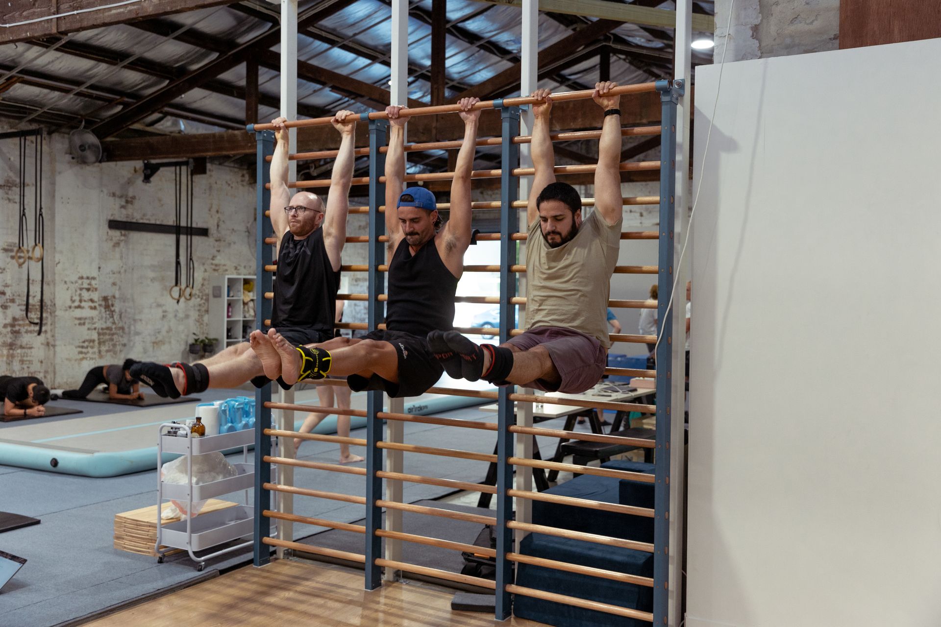 Image of people doing L situp in the gym