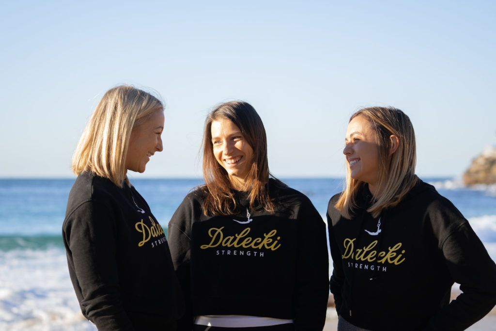 Image of three woman smiling at each other