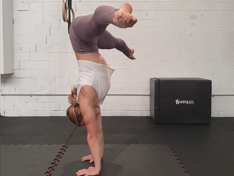 Image of a girl doing a handstand