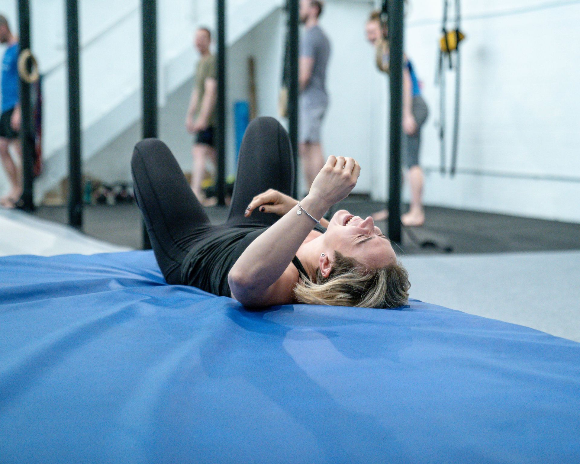 Image of a girl laughing on the gym floor