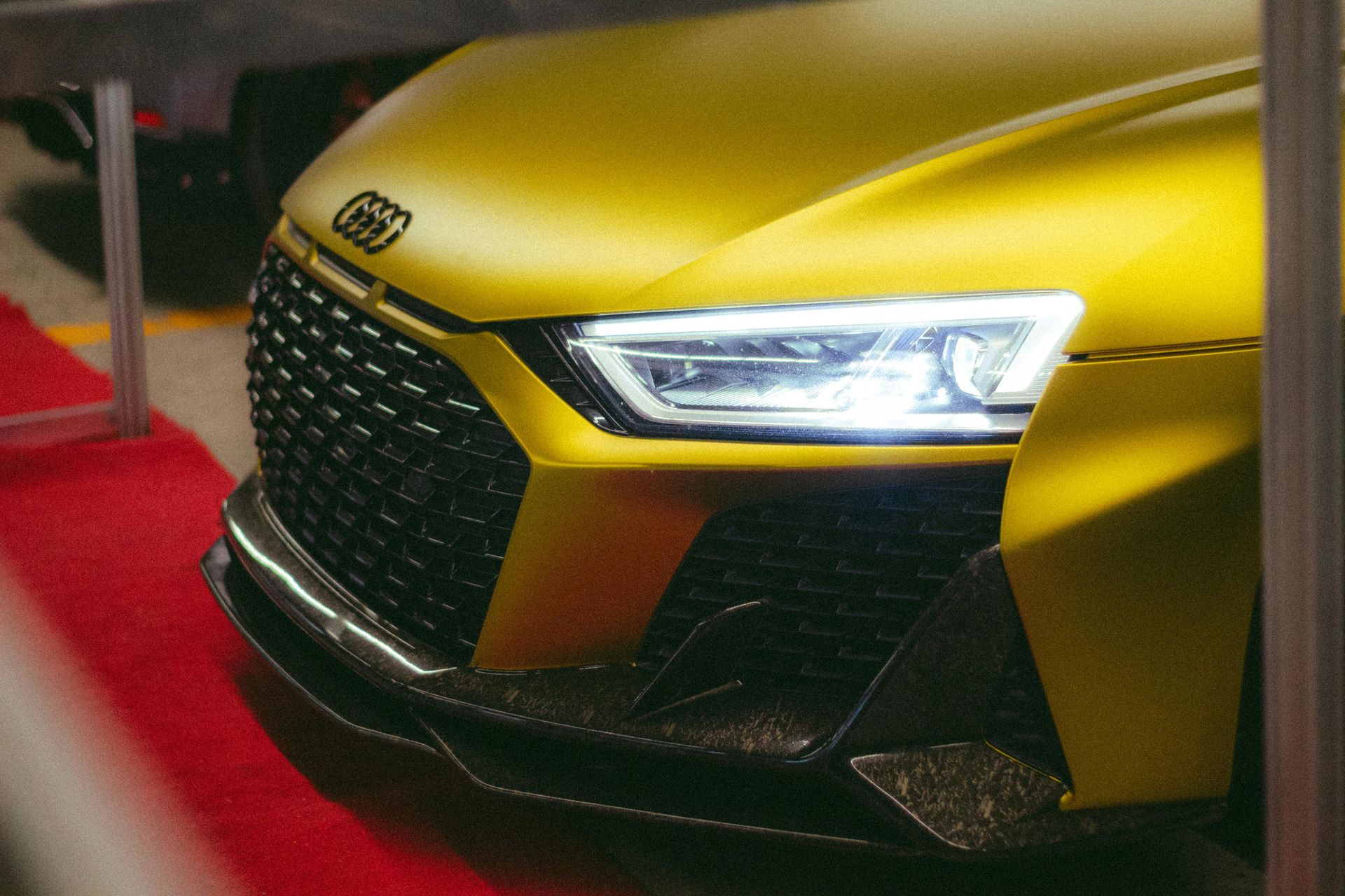 A close up of the front of a yellow car