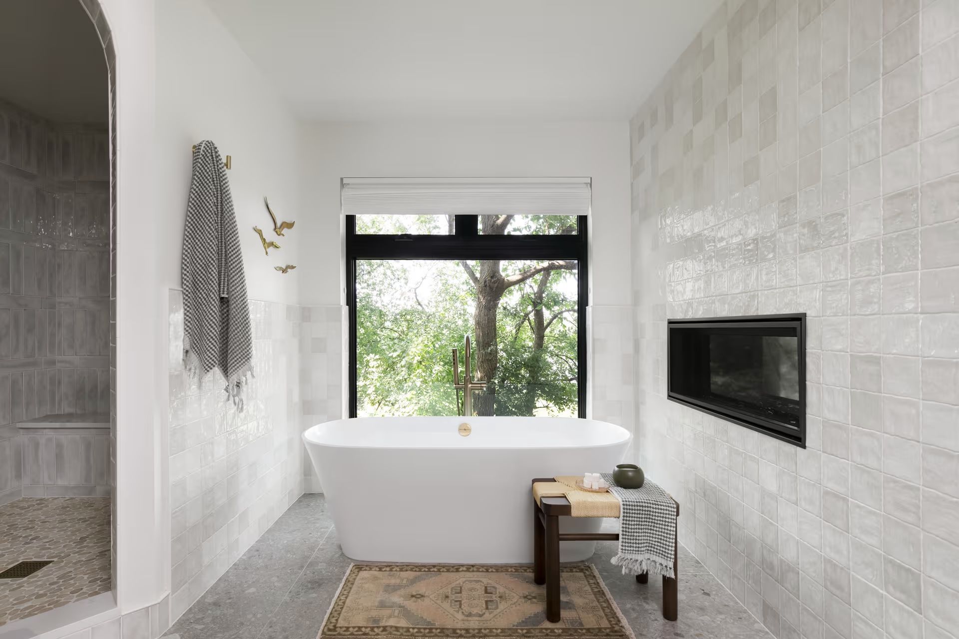 A bathroom with a tub and a window.