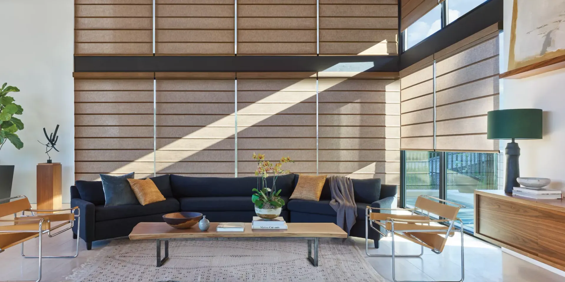 A living room with a couch , chairs , and a table.