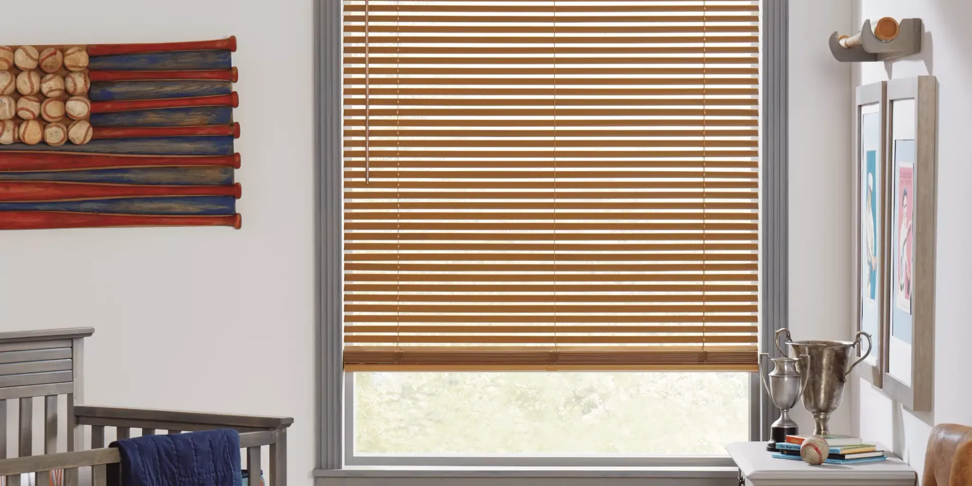 A room with a crib and a window with wooden blinds.