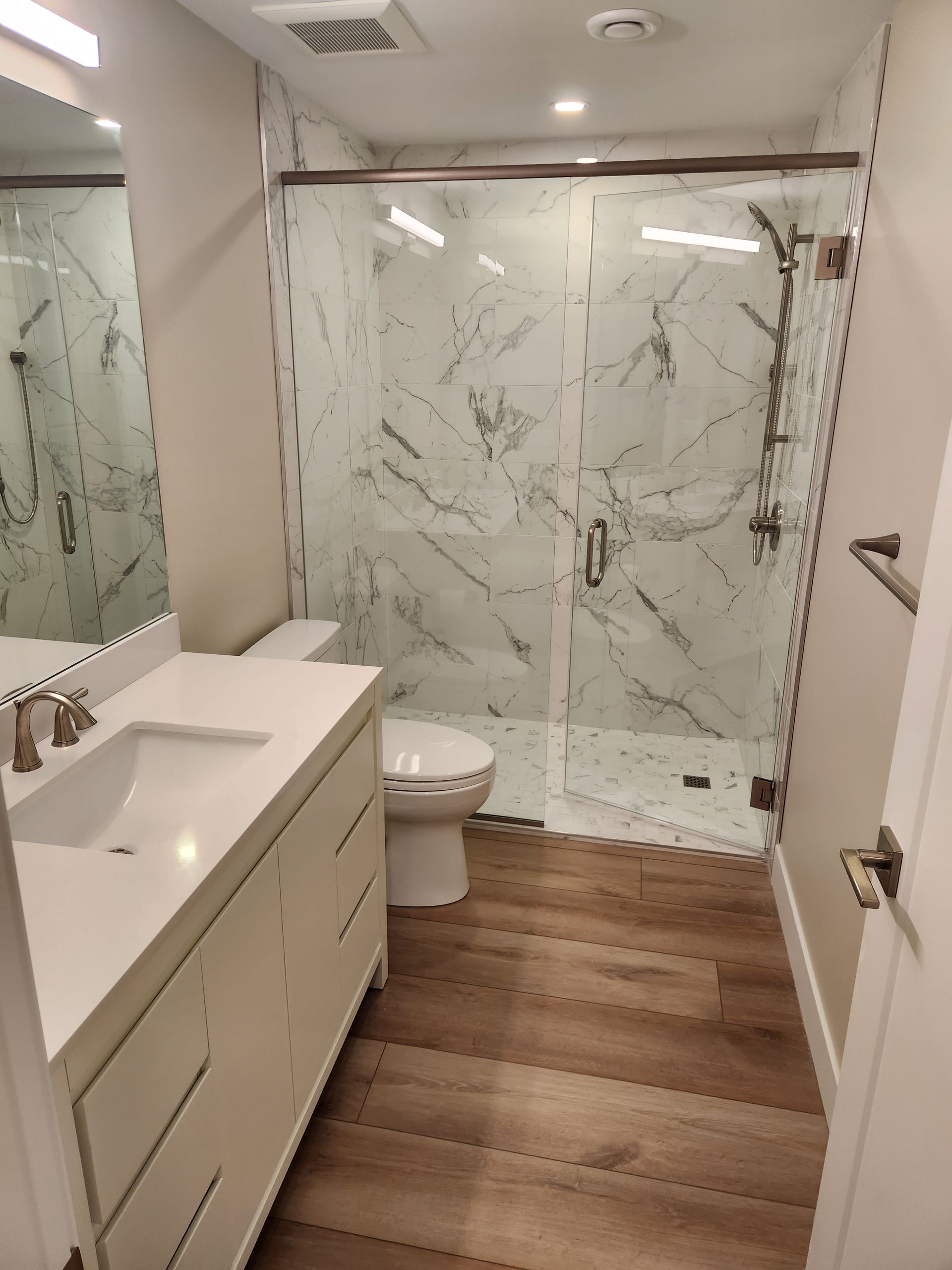 A bathroom with a toilet , sink , and shower.