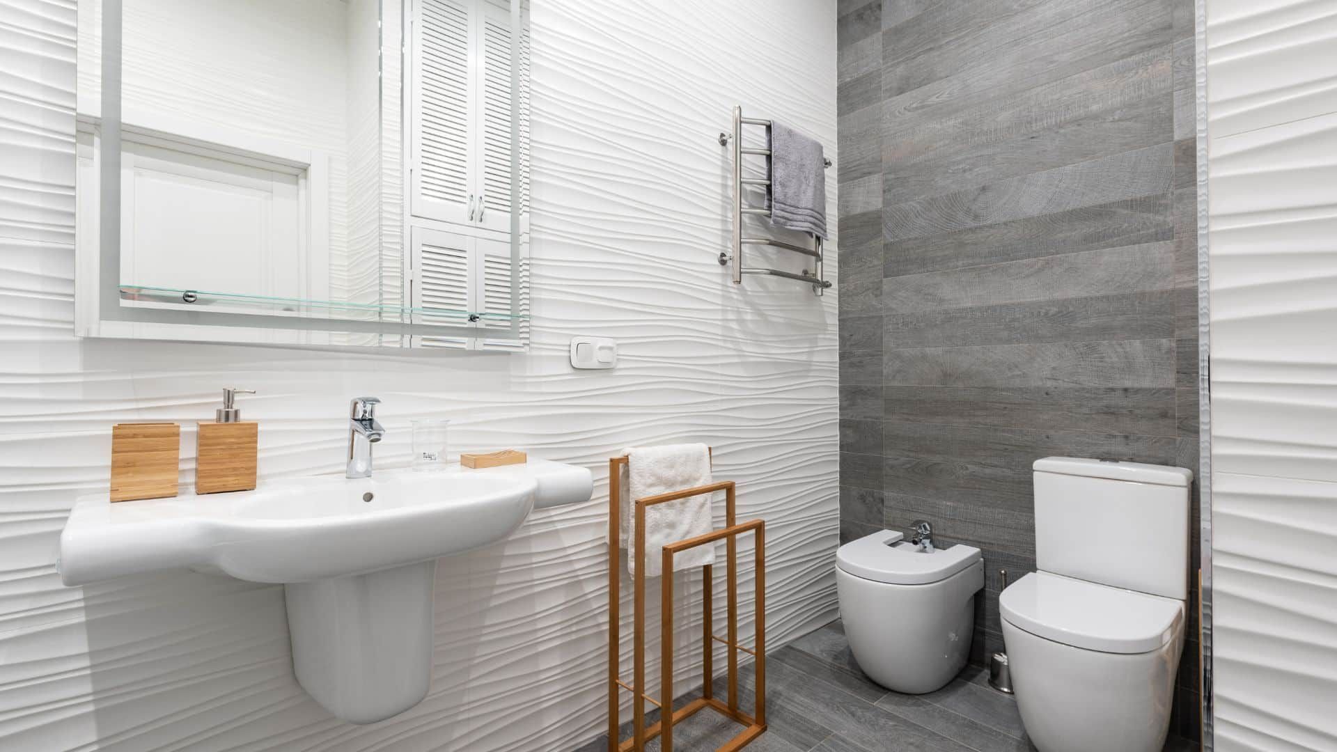 Contractor reviewing bathroom tile samples and plans with a homeowner