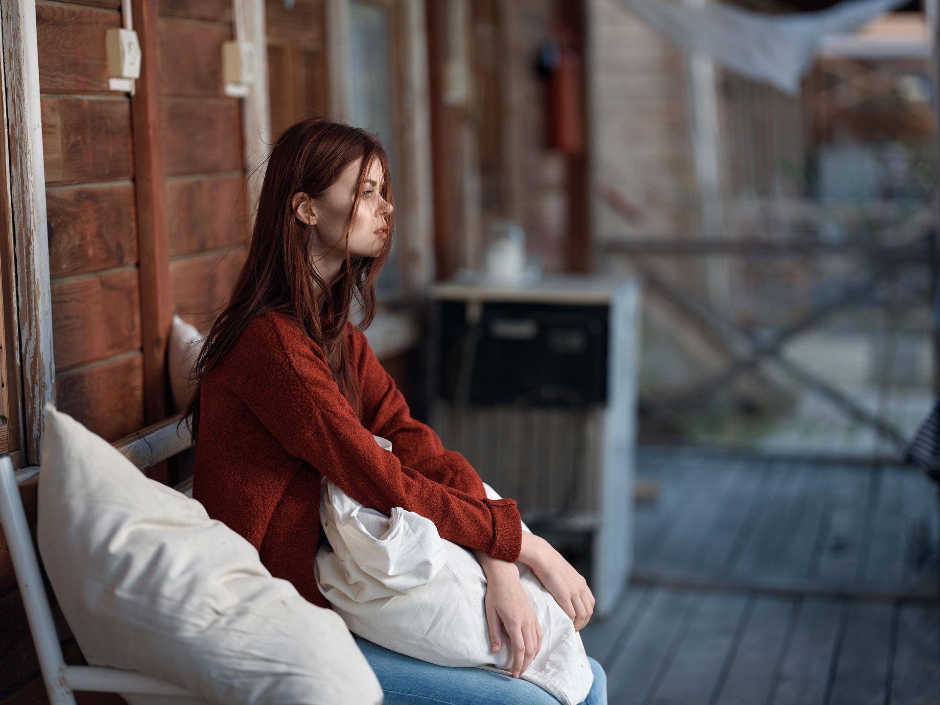 A woman is sitting on a couch talking to a therapist.