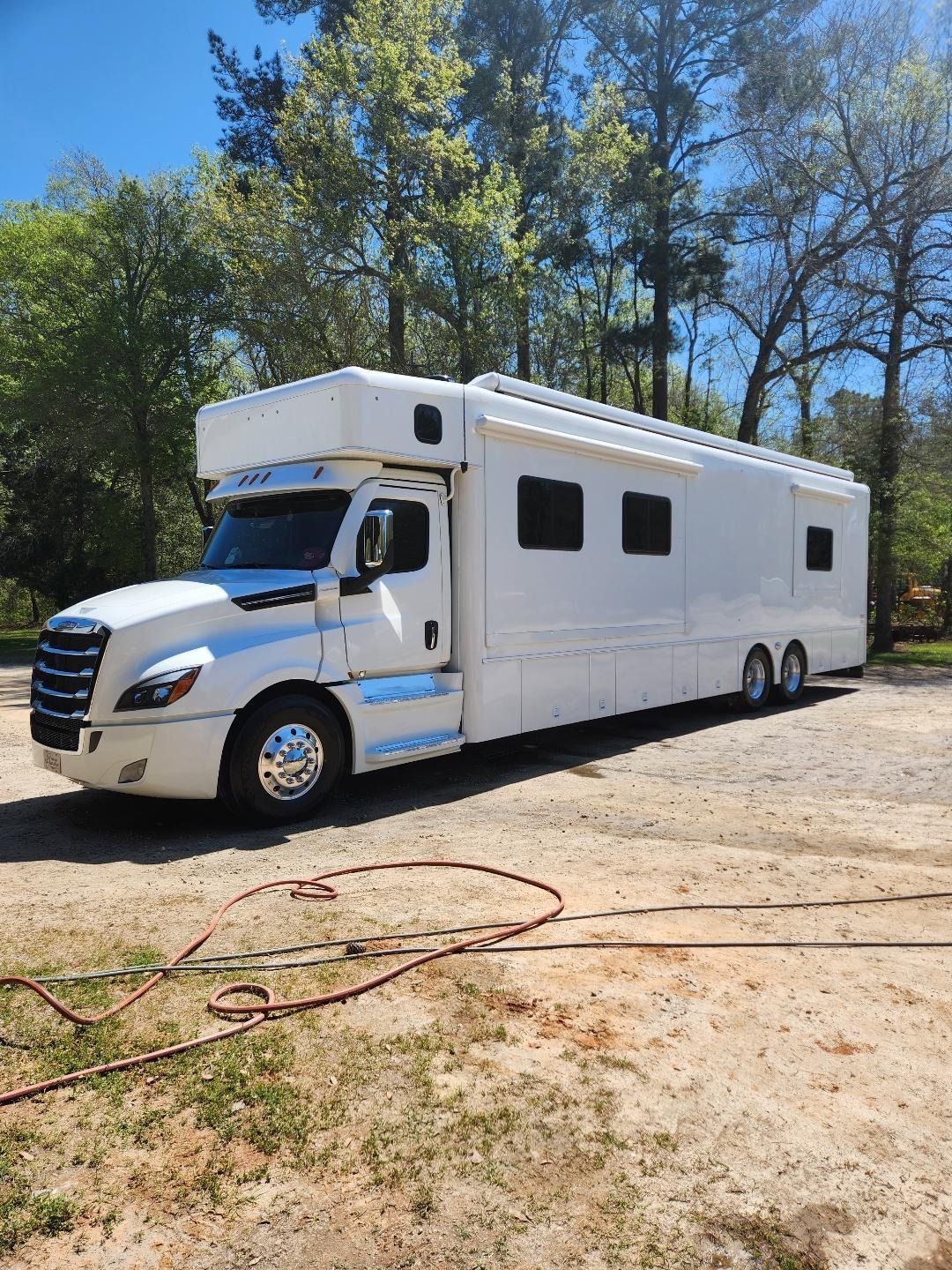 A White Freightliner-based Custom Motorhome Parked on a Gravel Lot — Valentine Detailing LLC in Walterboro, SC