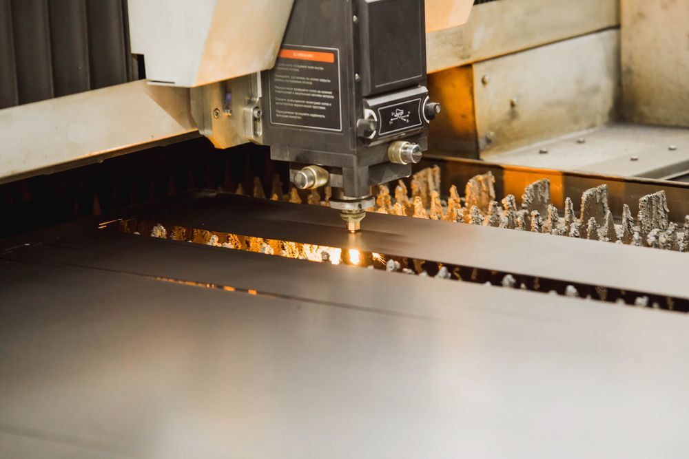 A Machine Is Cutting A Piece Of Metal In A Factory — Absolute Steel Fabrication & Welding In East Wagga Wagga, NSW