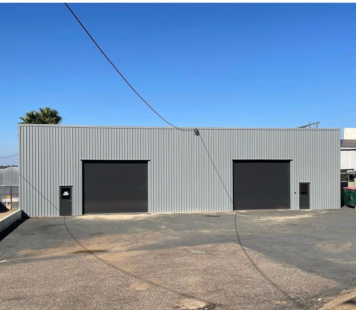 A Large White Building With A Blue Sky In The Background — Absolute Steel Fabrication & Welding In East Wagga Wagga, NSW