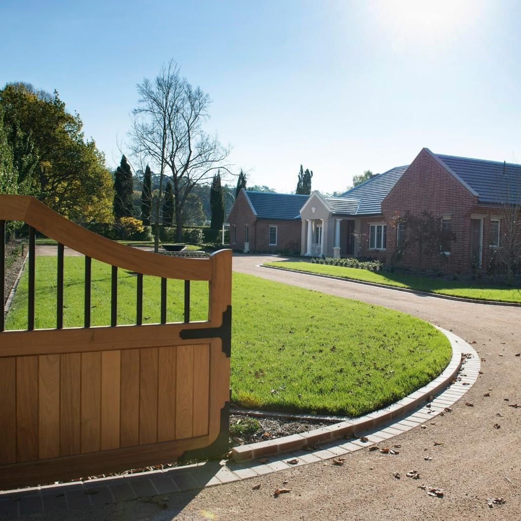 An View of A Large House with driveway and large gate — GMT Builders Pty Ltd in Burradoo, NSW