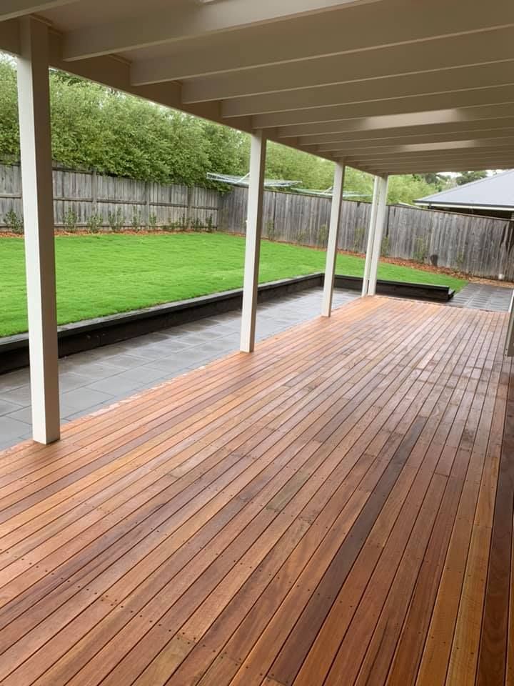 A Large Wooden Deck with A White Roof and A Fence in The Background — GMT Builders Pty Ltd in Moss Vale, NSW