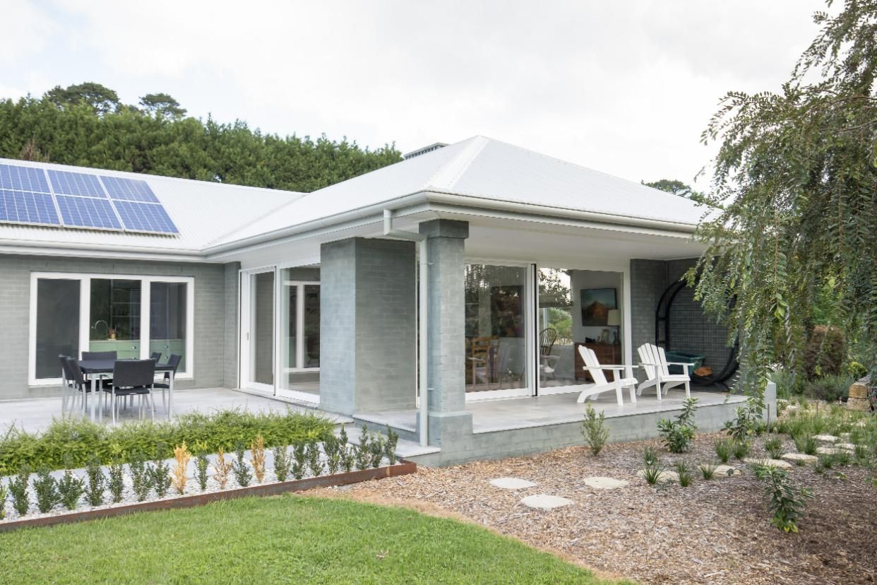 A House with A Patio and Solar Panels on The Roof — GMT Builders Pty Ltd in Berrima, NSW