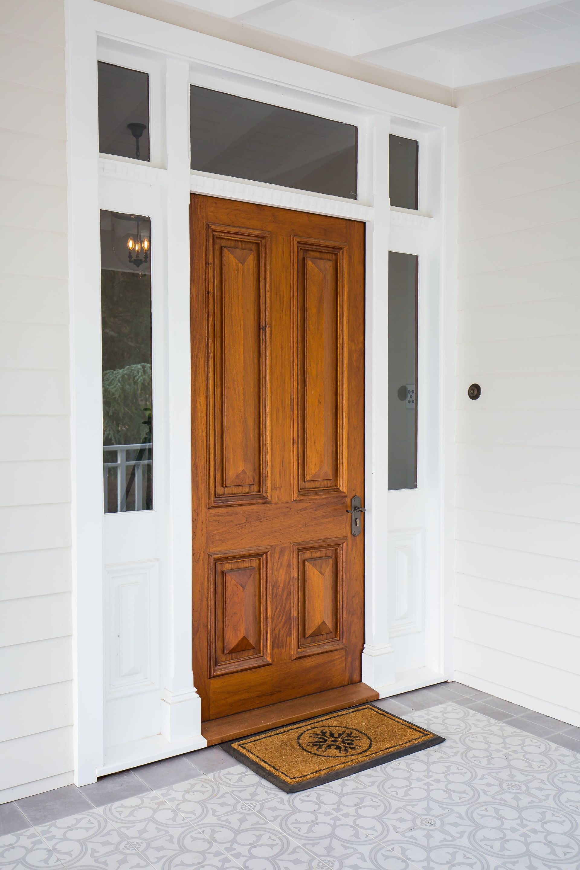 A wooden door with a door mat in front of it — GMT Builders Pty Ltd in Bowral, NSW