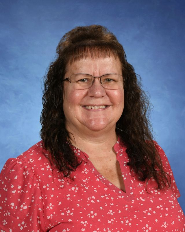 A woman in a black jacket and red top smiles for the camera. This is Hannah Pfeifer.