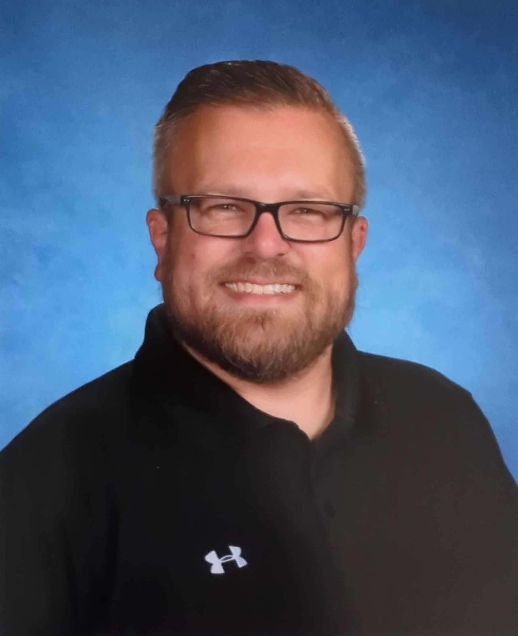 A man with glasses and a beard is wearing a black shirt. This is Brian Mears.
