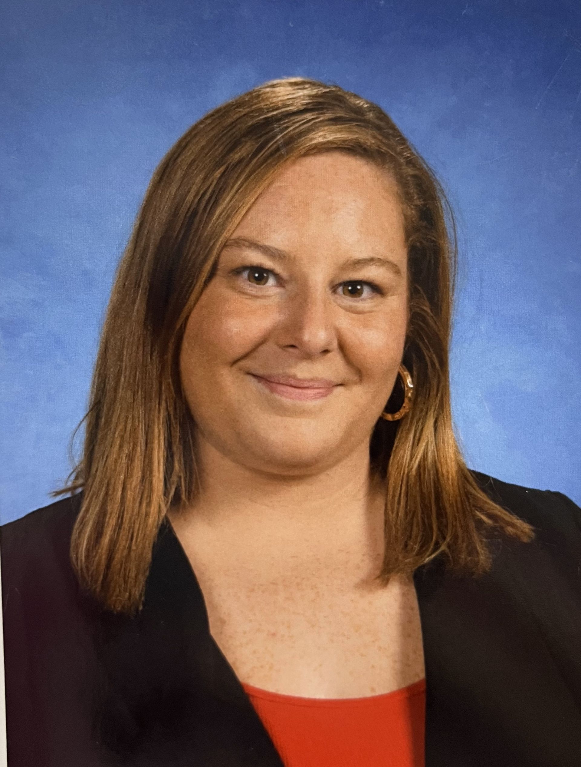 A woman in a black jacket and red top smiles for the camera. This is Hannah Pfeifer.