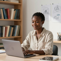 Person smiling at a desk with a laptop in a book-lined office