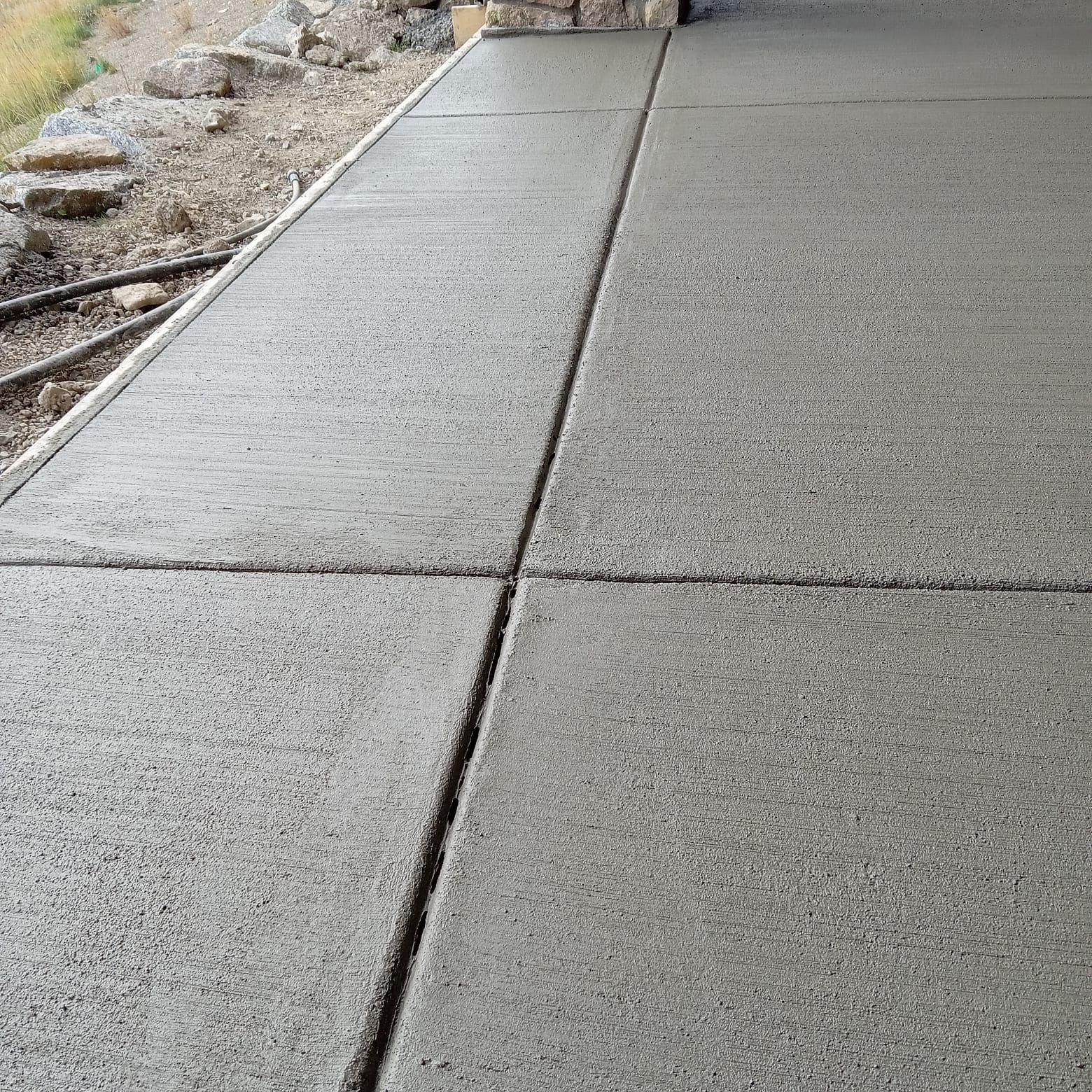 Freshly poured concrete patio with control joints.